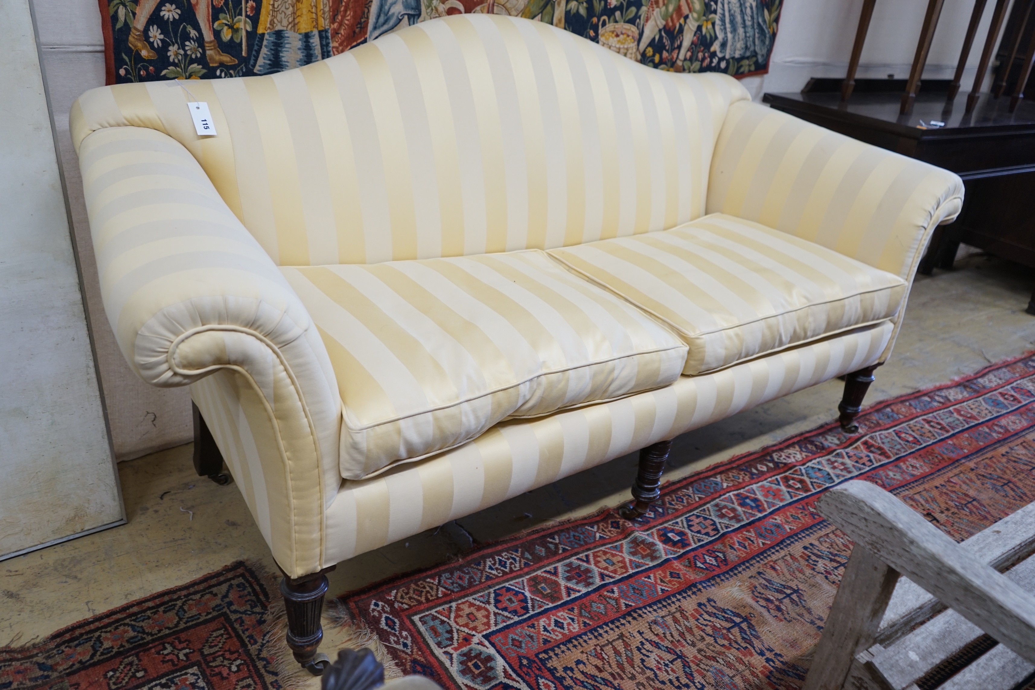 A Victorian scroll arm settee upholstered in ivory and gold striped fabric, length 186cm, depth 78cm, height 99cm